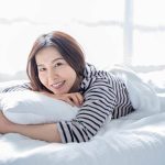 Woman sleeping peacefully on LOFE organic buckwheat pillow with perfect neck alignment