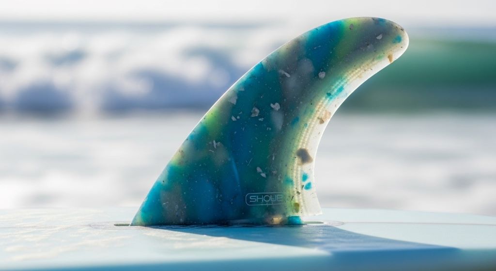 Close-up of eco-friendly surfboard fin made from recycled ocean plastic attached to surfboard