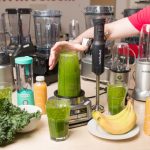 Affordable kitchen blender making a fresh fruit smoothie on a countertop.