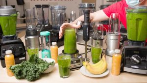 Affordable kitchen blender making a fresh fruit smoothie on a countertop.