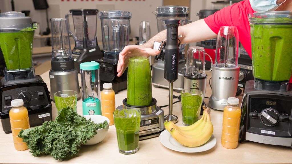 Affordable kitchen blender making a fresh fruit smoothie on a countertop.