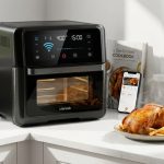 Modern smart air fryer oven on a kitchen counter displaying digital touchscreen menu.
