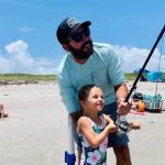 Parent helping a young angler use the perfect starter fishing pole