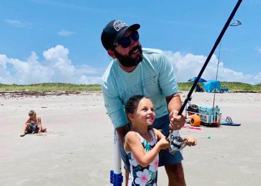 Parent helping a young angler use the perfect starter fishing pole