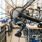 Close up view of modern mountain bike components highlighting frame and gears.