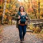 Plus-size mother wearing a budget baby carrier in a Pennsylvania park.